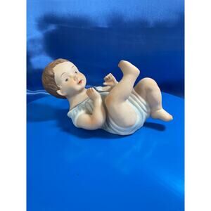 Vintage Bisque Piano Baby Dressed in Blue Outfit and has Brown Hair